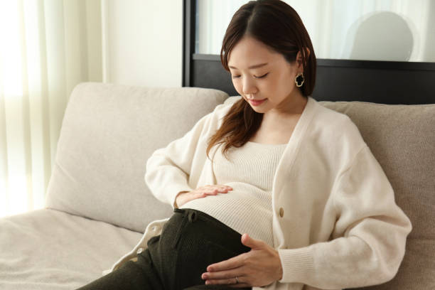 istock Pregnant woman sitting on sofa 2192598957