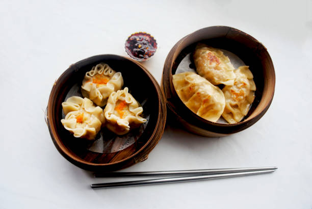 istock Isolated dim sums and chop sticks on the table. 2192607392