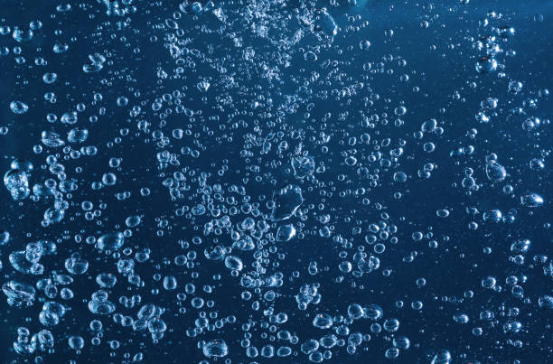 istock Close-up of blue bubbles underwater. Underwater oxygen design concept. 2192607985