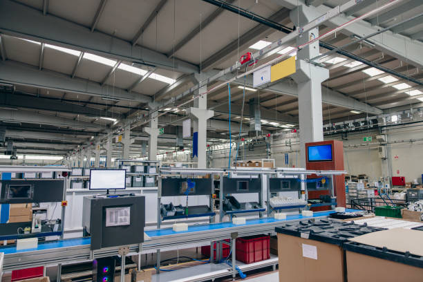 High angle aerial view of an empty electronic industrial building with injection molding CNC machine parts putting, checking and testing industrial equipment cables for serving the white goods and electric electronics sectors in modern large wire and cable manufacturing plant factory warehouse.