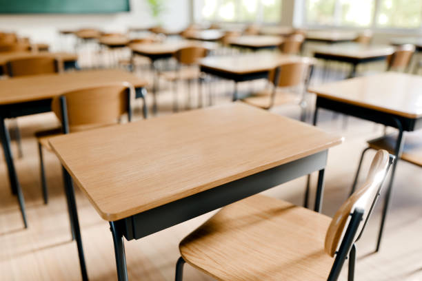 istock Desks and chairs arranged in classroom setting, perfect for students to engage in their studies. 3d render. 2192608634