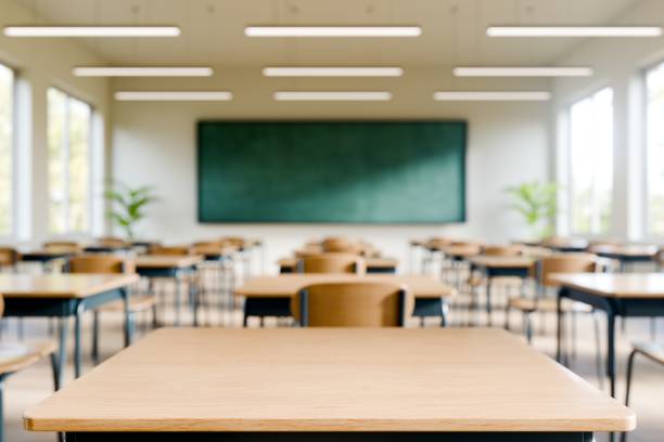 istock Bright and spacious modern classroom with desks and black chalkboard. 3d render. 2192608652