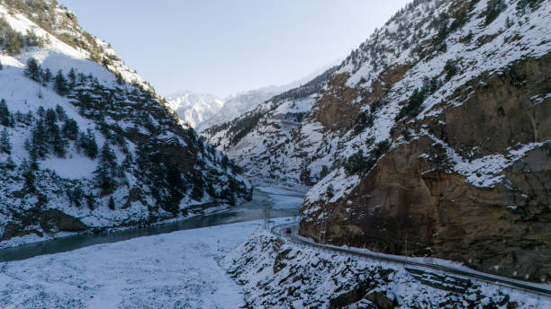 istock A serene Himalayan river winding through snow-covered valleys and rugged mountains, 2192609063