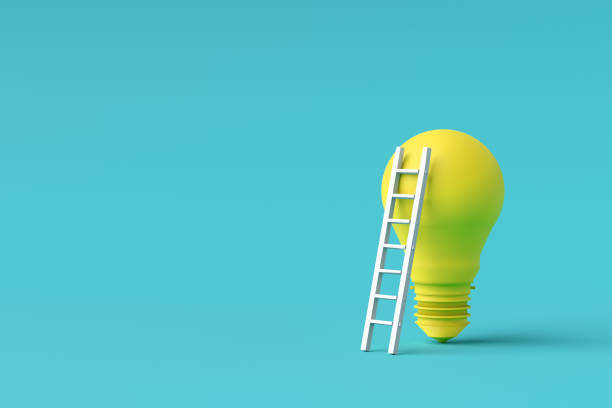 istock White ladder leaning on big yellow light bulb on turquoise background symbolizing innovation 2192611329