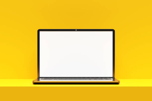 istock Modern laptop showing blank screen on yellow desk and background 2192611452