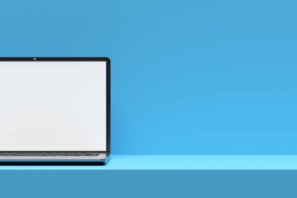 istock Modern laptop showing blank screen on blue desk and background 2192611458