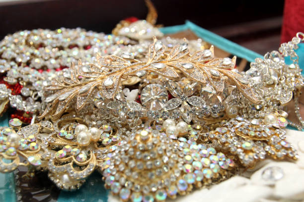 Beautiful fashion jewelry with precious stones, pearls and diamonds  for women. Many precious shiny jewelery from yellow and white gold, trendy glamorous jewel set: necklace, earrings, rings, chains, brooches