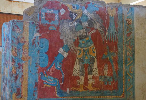 Small carved stone plaque in Uxmal showing  a Mayan King surrounded by snakes.