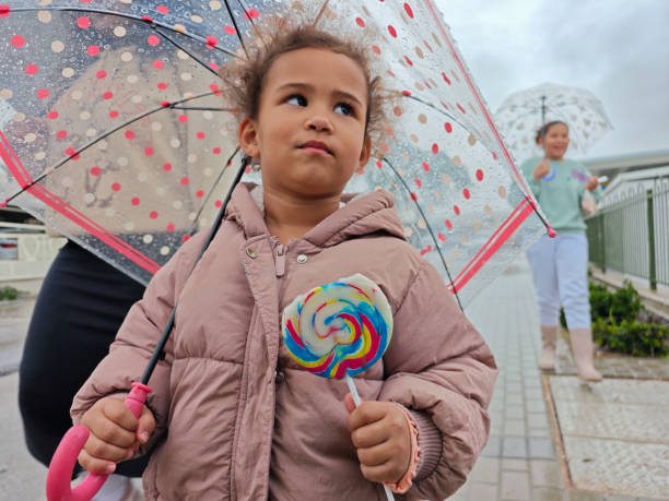 istock Strolling on a Rainy Day with Lollipops. 2192613536