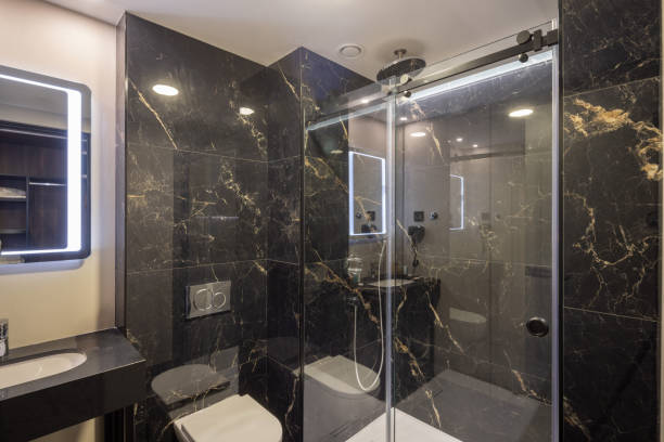 istock Bathroom interior with brown marble wall and glass shower cabin 2192615415