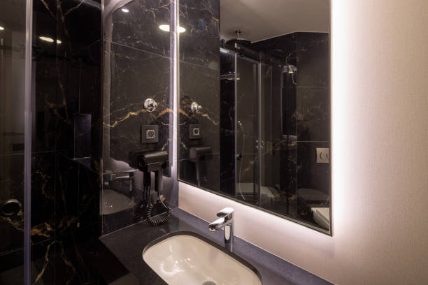 istock Bathroom interior with brown marble wall and glass shower cabin 2192615484
