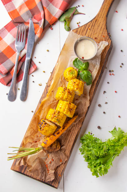 istock Grilled corn is served on wooden board 2192615569