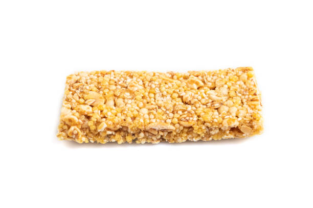 istock Granola bar with, caramel, nuts, flakes isolated on white. Side view, close up. 2192618634