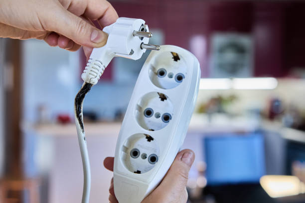 istock An electrical extension cord with tee became charred and caused short circuit due to overload. 2192619173