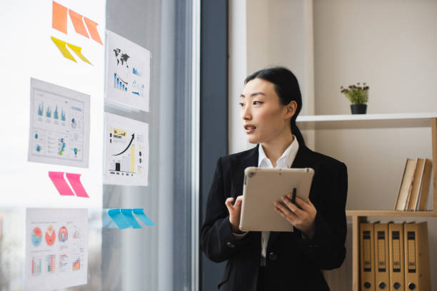 istock Asian businesswoman presenting analysis with digital tablet 2192621653