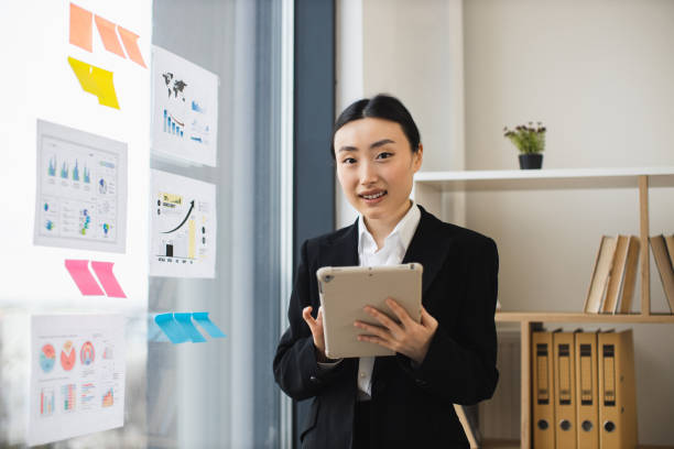 istock Asian businesswoman using tablet in modern office environment 2192621657