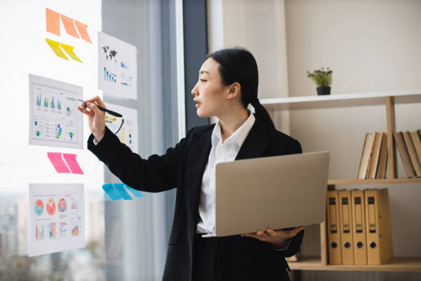 istock Professional asian businesswoman using laptop in modern office setting 2192621669