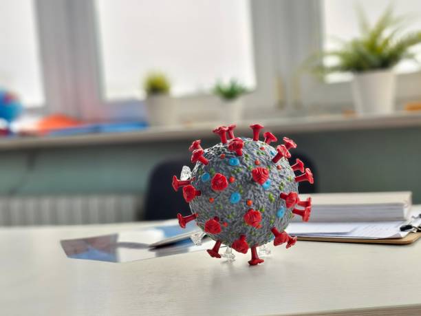 istock 3D representation of a virus model on a desk in a classroom 2192622400