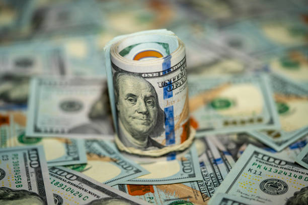 istock Stacked cash with rolled bills creating a financial backdrop 2192623710