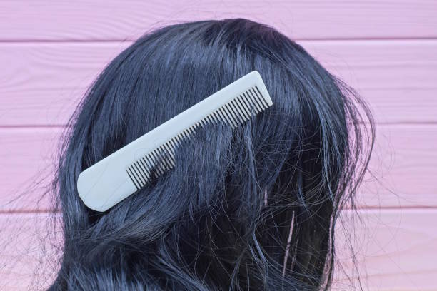 one white plastic comb in black long hair