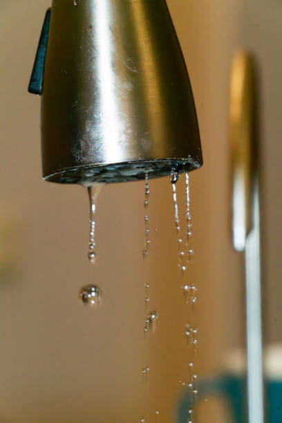 istock Water droplets fall from a kitchen faucet in a modern home setting 2192625572