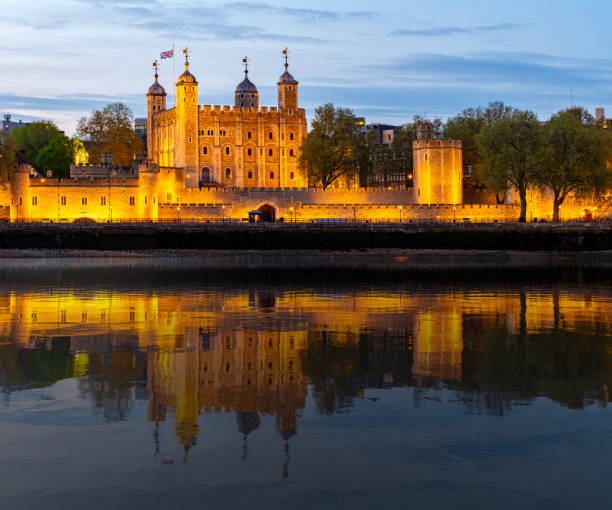 istock Tower of London at sunset reflected in Thames river, UK 2192633243