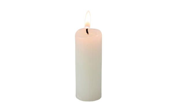 istock Burning ribbed pillar wax candle isolated on white 2192633282