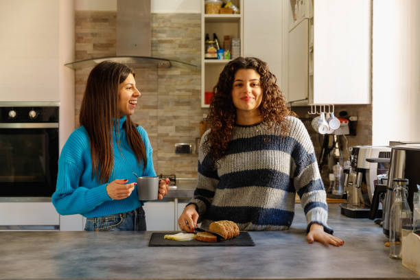 istock Two young women have good time in a domestic kitchen 2192634470