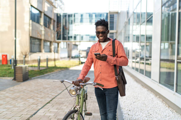 istock A handsome young man with a bicycle on the city street 2192636628