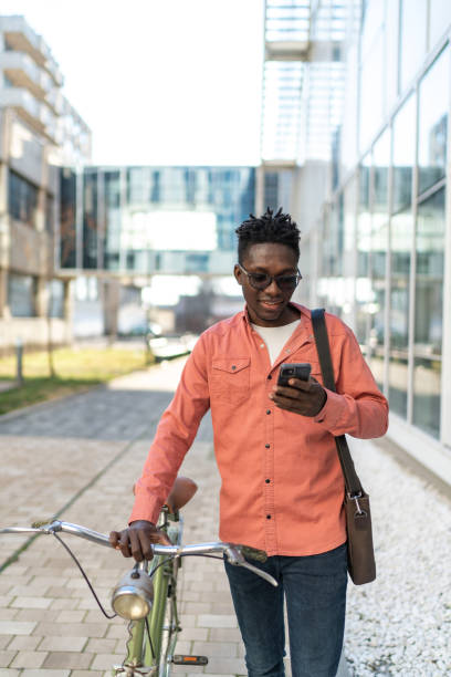 istock A handsome young man with a bicycle on the city street 2192636728