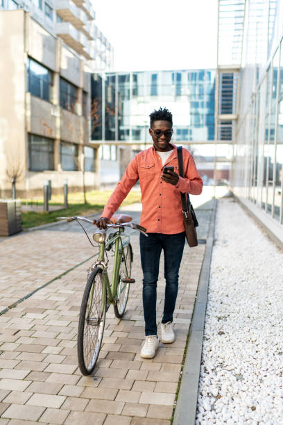 istock A handsome young man with a bicycle on the city street 2192636767