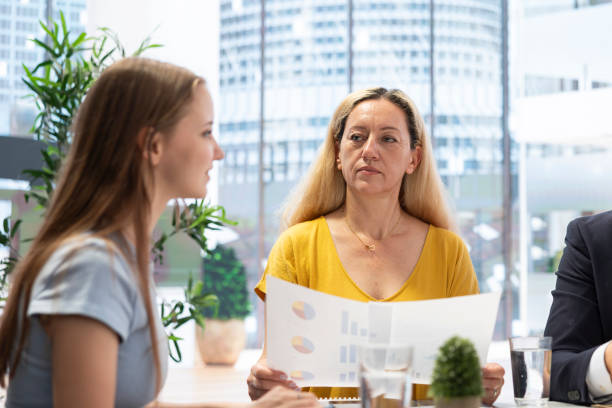 istock Clients looking over statistical charts given by financial advisor in office 2192637169