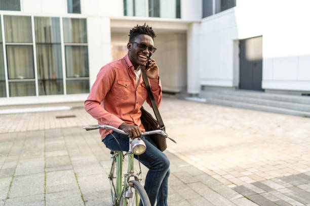 istock Young man with bike using cell phone 2192637892