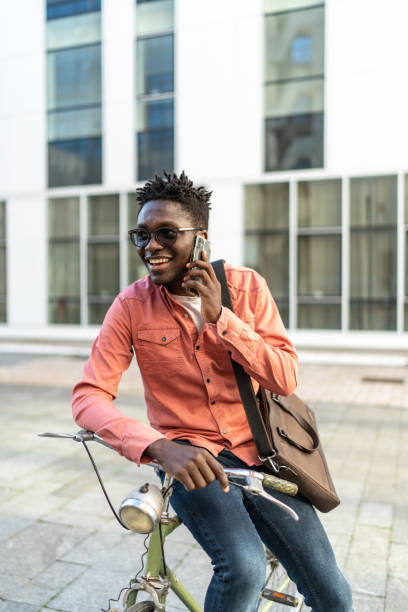 istock Young man with bike using cell phone 2192637969