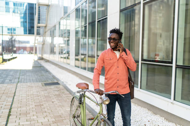 istock Young man with bike using cell phone 2192638037