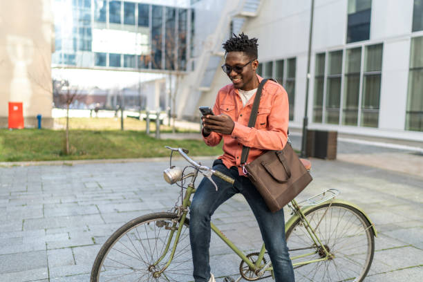istock Young man with bike using cell phone 2192638106