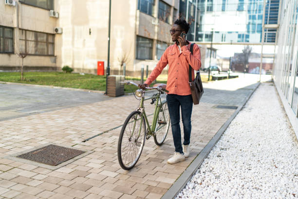 istock Young man with bike using cell phone 2192638299