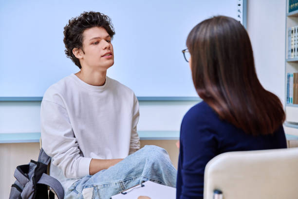istock Psychologist working with young male college student in educational office 2192641004