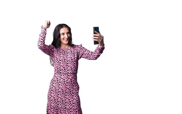 istock A mature lady in elegant dress having video chat with her relatives using smartphone 2192642109