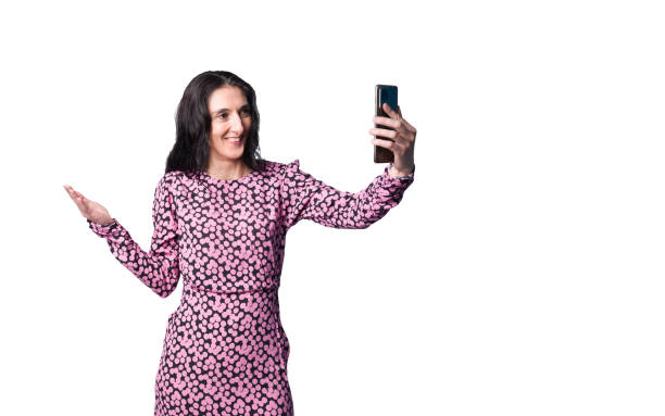 istock A mature lady in elegant dress having video chat with her relatives using smartphone 2192642110