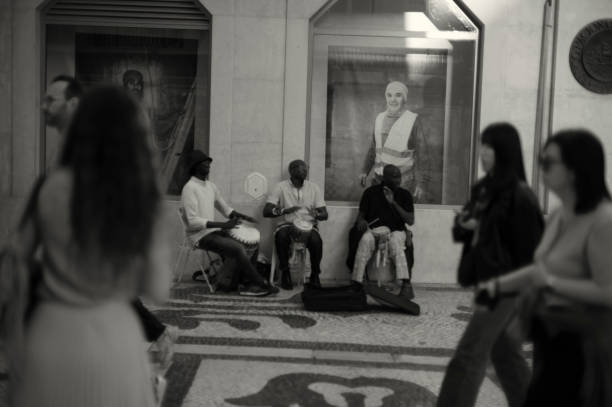 Lisbon, Portugal - November 2, 2024: A trio of african street musicians performs at the Rua Augusta street in Lisbon downtown.