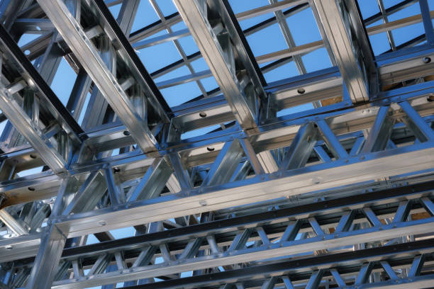 istock Close-up view of a steel frame structure under construction with a clear blue sky in the background. 2192643248