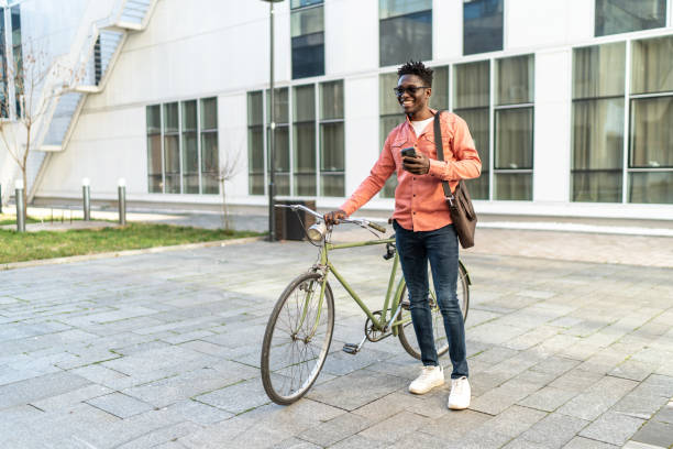 istock Handsome young man holding coffee and his bike 2192643980
