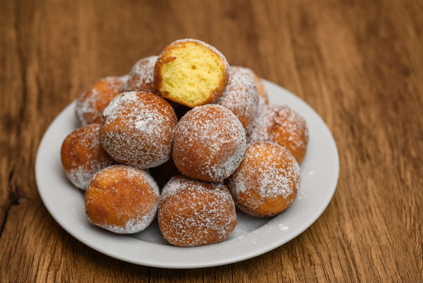 istock Mini donuts with powdered sugar stacked on a plate 2192645852