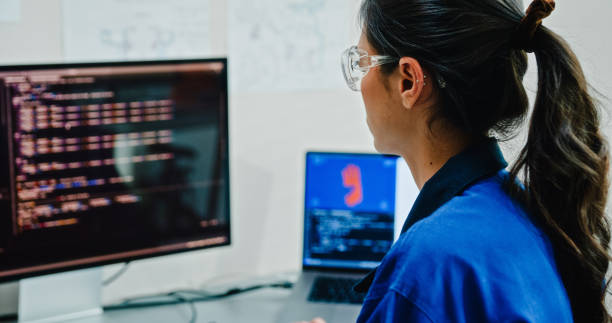 istock Closeup Young female engineer work on controlling robotic arm in tech lab. Display AI and robotics hand design operates machinery and analyzes data for innovation. AI and Robotics Development. 2192646860