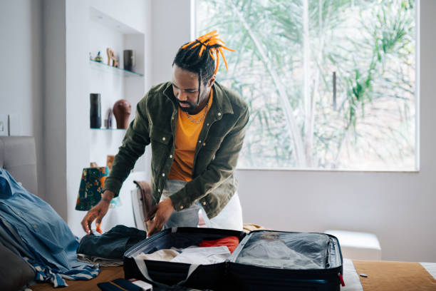 istock Young man packing bags for a trip 2192647867