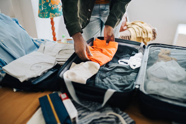 istock Close up of a man's hand packing bags 2192647879