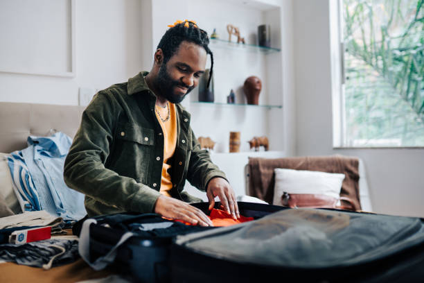 istock Young man packing bags for a trip 2192647923