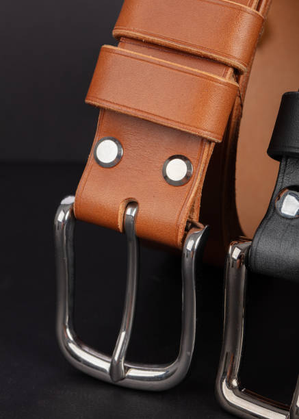 istock Leather belts with metal buckles on a gray background. 2192649103