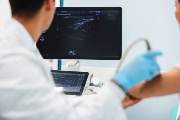 istock Doctor Examining Patient with Ultrasound Technology 2192649605